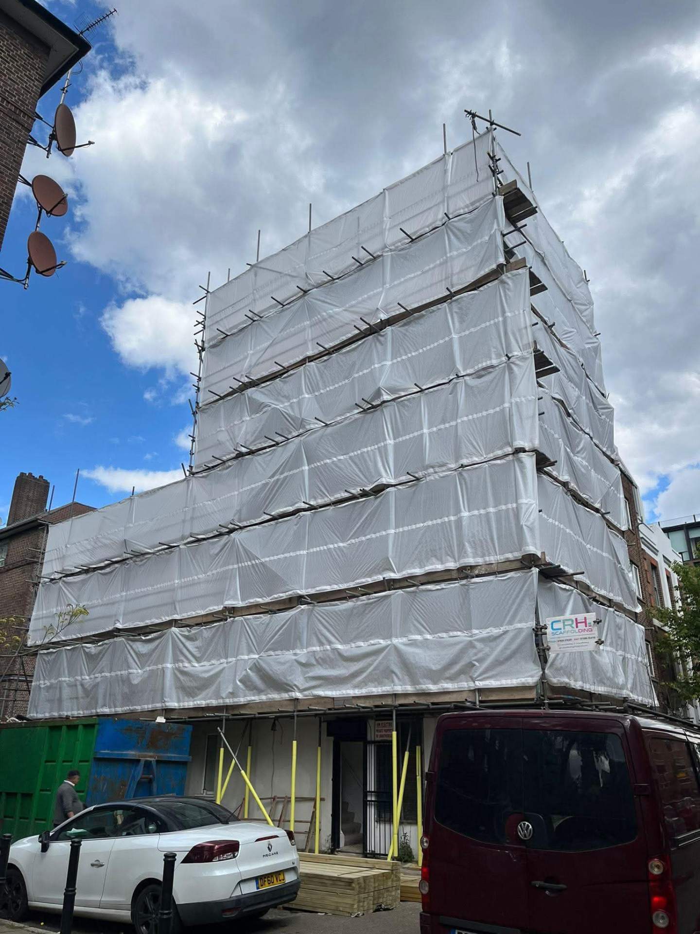 Fully sheeted scaffolding on a four storey building